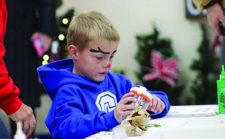 Garrett Pierce decorates a sugar cookie during Christmas In The Park’s Lighting of the Park festivities Saturday, Nov. 25 at Fair Park City Auditorium. The Red River Sun/Elizabeth Tanner