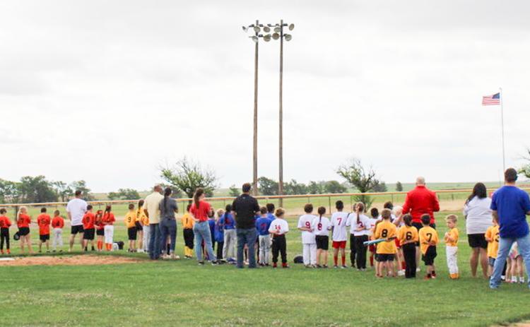 Wellington Little League teams turn toward the American flag for the Star-Spangled Banner during Opening Day ceremonies at 10 a.m. Saturday, April 10 at Marion Airpark Baseball Field. Parents, friends and baseball fans packed the park to get a glimpse of the players.