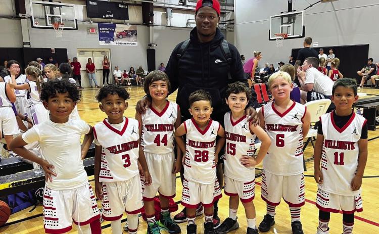 Wellington Elite team members Carmelo Coffee, left, Jaxon Coffee, Easton Ryan, Lincoln Mayer, Coach Prentice Coffee, Luke Roberson, Landry Mixon and Kase Reyes plan for their next basketball competition Saturday, June 17. The kindergarten through second-grade team competed in the Hoop 10 one-day summer wrap-up tournament at the Amarillo Netplex. Not pictured is Noah Peters. Courtesy Photo