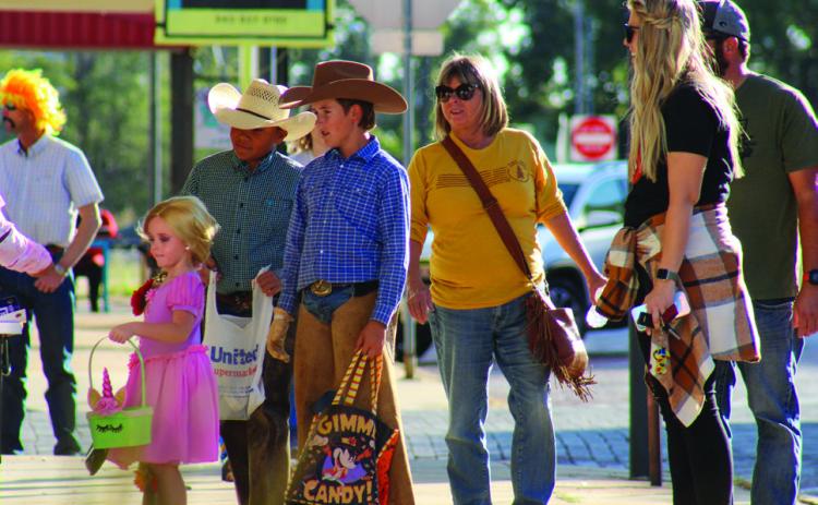 Trick-or-treaters Bryar Chapman, left, Bryson Session and Slade Chapman, accompanied by Debbie Chapman, Kelsi Chapman and Jake Chapman, attend the 2021 Childress Main Street Downtown Trick-or-Treating event. This year, the annual event will be held from 5-6 p.m. Saturday, Oct. 29 on Main St. and Commerce St. The Red River Sun/Elizabeth Tanner