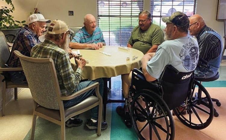 Volunteers, clockwise from left, Joe Stewart, Harry Stallings, Dale Day and John Lively compete with Tommy Baker and Steven Tucker during a recent domino challenge at Wellington Care Center. The volunteers report that a good time was had by all participants. Courtesy Photo