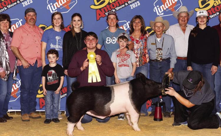 Wellington High School senior Hunter Stark earns fifth place with his heavy middle weight Hampshire and a place in the sale at the recent 2023 San Antonio Stock Show and Rodeo. Front row, from left: Maxon Orr, Stark, Maverick Orr. Back row, from left: Weldon Walser, Annette Walser, Matt Orr, Brooklyn Teeters, Kamryn Teeters, Marcie Orr, Veronica Gray, Ed LaGrone, Claud Crisp, Emma Flores, Kenny Patterson, Brooke Patterson. Courtesy Photo