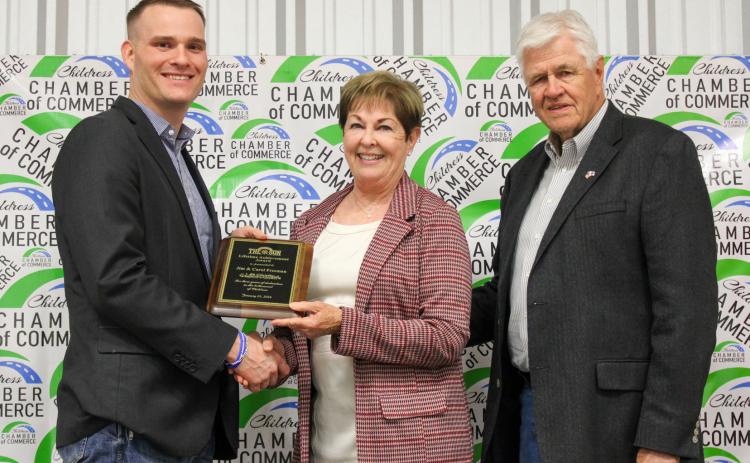 Jim and Carol Freeman receive the Lifetime Achievement Award, presented by Childress Chamber of Commerce Board of Directors member Travis Brooks, during the 2025 Childress Chamber of Commerce Banquet Awards Ceremony Monday, Feb. 16 at the Mashburn Event Center. The Red River Sun/Elizabeth Tanner