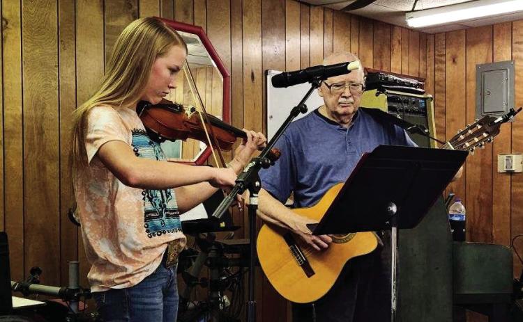Monson Music Studio’s RayLee Elliot, the 13-yearold daughter of Shawn and Shaley Elliot, plays the violin while singing the verses of three songs, including “Faded Love” by Bob Wills, “Tennessee Waltz” by Patti Page and “Let’s Go Riding on a Cloud,” at a recent Childress Senior Citizens Center luncheon. Accompanying her on guitar was Monson Music Studio instructor Gerald Monson. Courtesy Photo