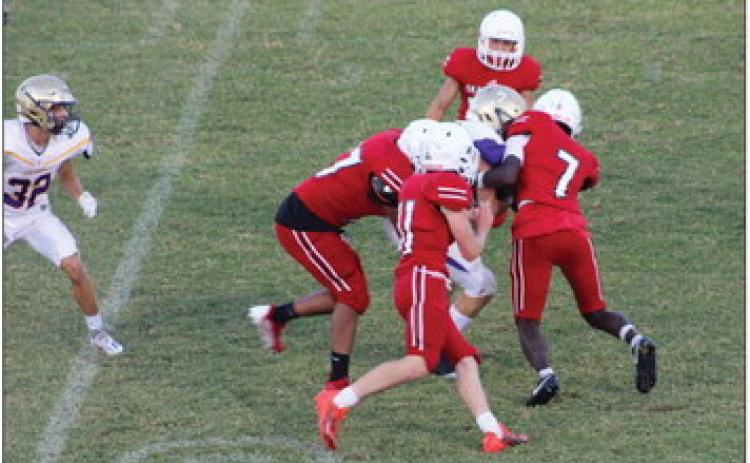 Junior varsity Rockets Kamron Brooks (7), Conner Bowen (11), Yobani Moreno (77), with other Rockets coming in to assist, take down a Panhandle Panther in a game on home turf last Thursday, Sept. 22. Wellington took the 28-20 win to remain undefeated on the season. The Red River Sun/Shauna Salinas