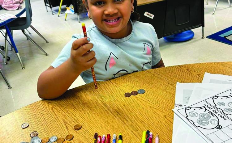 Travis Elementary School teacher Kaprisha Casas’ kindergarten students learn to count money. Students were even able to use the play money to purchase pencils. Photos Courtesy of Memphis ISD