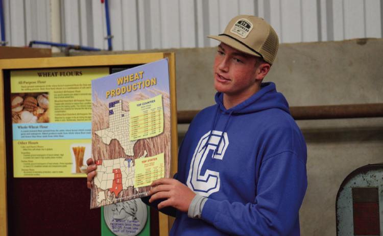 Childress High School sophomore Cutter Bruce shares wheat production facts, including the top-producing Texas counties and states, with area fifth-grade students at the 2023 Childress County Ag Day Wednesday, Nov. 1 at the Mashburn Event Center and Arena. The Red River Sun/Elizabeth Tanner