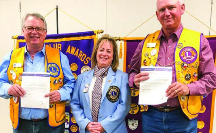 District 2-T1 Governor Deanna Porter presents Lion Neal Odom, left, a 15-year membership pin and Lion Rex Henard a 25-year membership pin during the Monday night, Nov. 17 meeting. The Red River Sun/Bev Odom