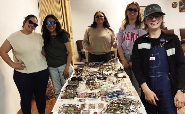 Leo Club assists Wellington Lions Club with packaging eyeglasses