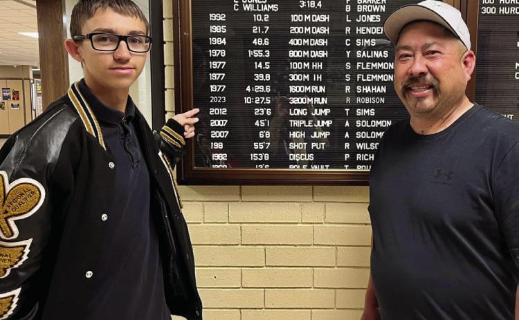 Memphis High School (MHS) junior Ryder Robison breaks the 3,200-meter school record with a time of 10:27.45 at the Bobcat Relays Thursday, March 23. Jesse Chavira, MHS Class of 1994, congratulates Robison on breaking his record time, which was recorded in 1992, 31 years ago. Photo Courtesy of Memphis ISD