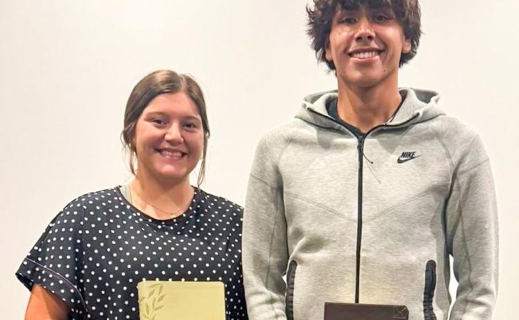 Eryn Torrez and Armando “Tiny” Hinojosa receive recognition and accept their bibles during the Sunday evening, May 11 service at Trinity Fellowship Church.