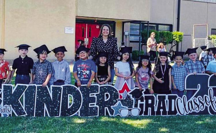 Kacy Cabbell’s kindergarten students celebrate their graduation with a special yard art sign. From left: Aliviah McGrady, Hallie Warren, Stratton Wynn, Ryker Justice, Kollin Hamner, Jaxon Coffee, Terrance Gonzales, Eliyah Navarro, Cabbell, Aubrie Rincon, Zayra Arizpe, Brynlee Holton, William Nanez-Melton, Landry Mixon, Layton Wynn, Katie Tarver, Jordan Alvarado. Courtesy Photos