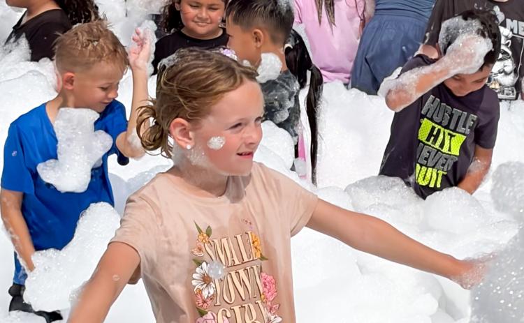 Summer readers frolic in library’s foam party