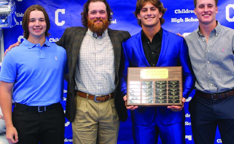 Head baseball coach Jonathan Wise, second from left, awards Bobcat Baseball Offensive Most Valuable Player (MVP) Scout Smith, second from right, and Bobcat Baseball Co-Defensive MVPs Aiden Allen, right, and Sawyer Dunlap, left.