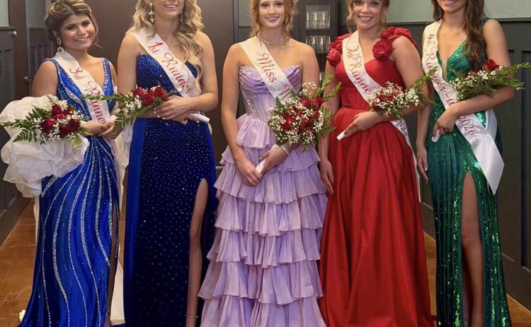 The 2026 Miss Wellington Scholarship Pageant Court, including junior Raelea Davila, third runner-up; junior Anna Needham, first runner-up; senior Bailey Page, Miss Wellington 2026; senior Ceighley Killian, second runner-up; and sophomore Anna Dwyer, fourth runner-up, pause behind the scenes following the Saturday evening, Oct. 24, pageant at the Wellington Ritz Theatre. WELLINGTON HIGH SCHOOL