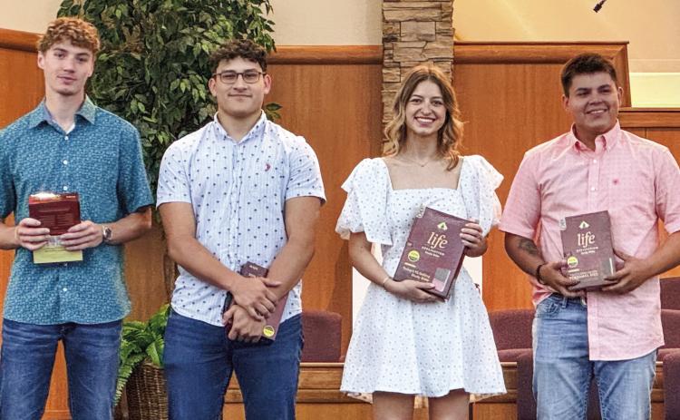 Members of the Wellington High School Class of 2024 receive recognition Sunday, May 5 during the morning worship service at First Baptist Church. Each student received a bible, presented by Kelli Killian. From left: Nixon Folk, Ethan Nevarez, Summer Neufeld, Tryston O’Rear. Courtesy Photo