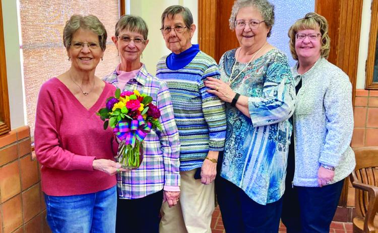 Modern Home Club member Margie Porter, left, wins the drawing for a floral centerpiece, provided by Catherines. From left: Porter, Linda Gooch, Ramona Garcia, Rosemary Foster and Sandra Moody. Modern Home Club