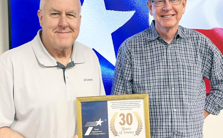 Texas Department of Transportation (TxDOT) Childress District Operations Jimmy Bridges, right, accepts a 30-year service award from TxDOT Childress District Engineer Darwin Lankford. For additional photos, see 8A. Texas Department of Transportation
