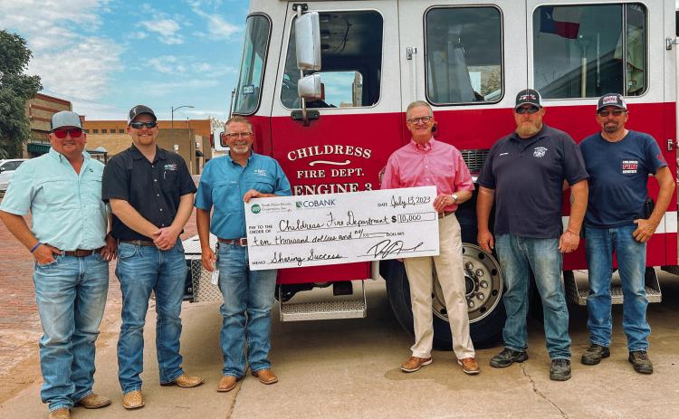 The Childress Fire Department receives a $10,000 donation from South Plains Electric Cooperative and CoBank to help them relocate their Firefighter Training Facility Thursday, July 13. Courtesy Photo