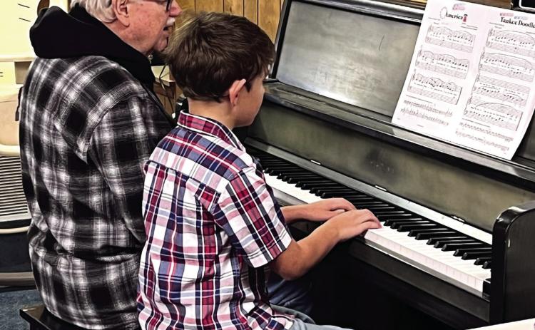 Monson Music Studio’s Benjamin Guajardo, a third-grade student at Childress Elementary School and the nine-year-old son of Jake and Stephnie Guajardo, entertains Thursday, Nov. 13 at the Childress Senior Citizens Center. In honor of Veterans Day, Guajardo, accompanied by Monson Music Studio owner and instructor Gerald Monson, performed five patriotic songs on the piano, including “America,” “Marines’ Hymn,” “Anchors Aweigh,” “Yankee Doodle” and “The Cassion Song.”