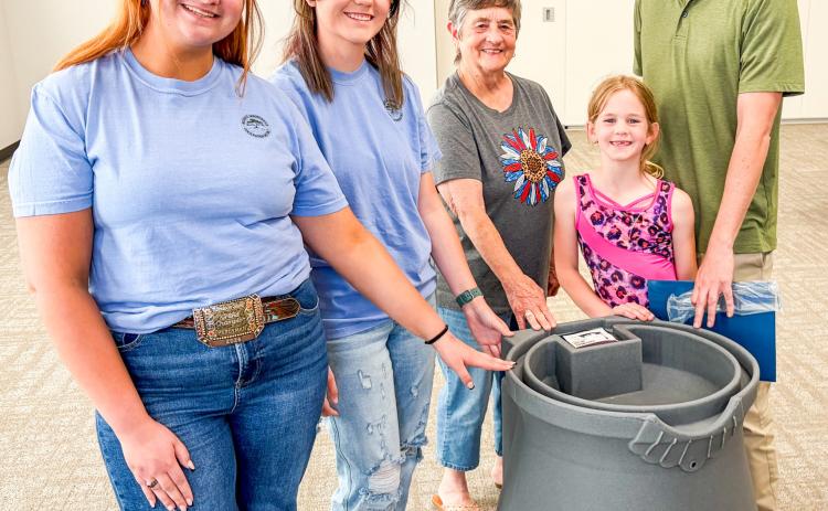 Accompanied by his youngest daughter, Kenney Keys claims the rainwater harvesting barrel drawing at the conclusion of the Tuesday, April 21 workshop. From left: Jacy Lampe, Jordan Altman, Saunna Blacksher, Mackenzie Keys and K. Keys. BEV ODOM/THE GREENBELT INTREPID