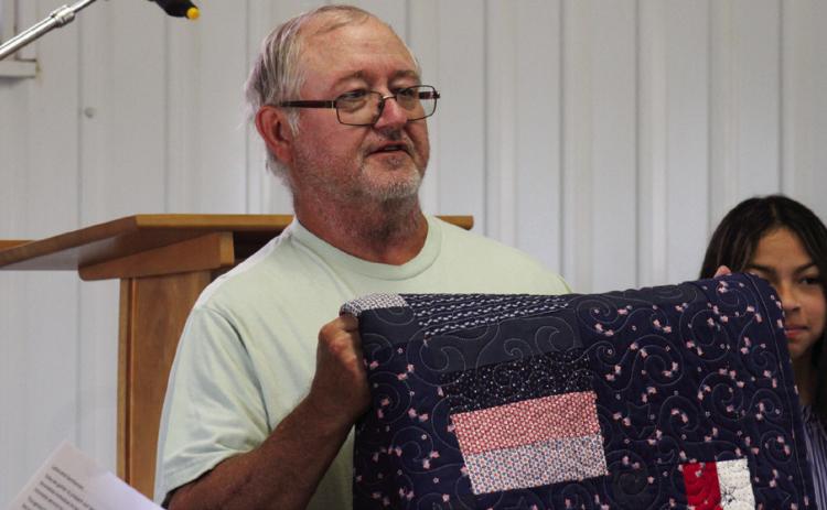 Veteran James Gray, U.S. Army Sergeant First Class, receives the second-ever Childress County 4-H Quilt of Valor at the Childress Elks Lodge #1113 Memorial Day Service Monday, May 26 at Jones Chapel in Childress Cemetery. The Red River Sun/Elizabeth Tanner