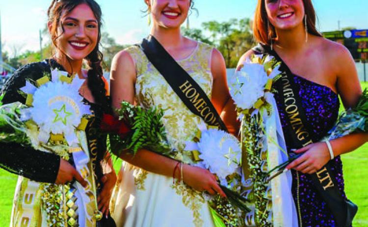 Queen nominees Audrey Chavera, left, and Ava Arant, right, surround 2022 Memphis High School Homecoming Queen Maggie Cook.