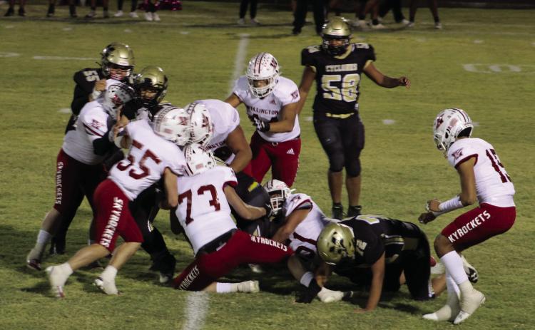 Skyrockets Dalton Holland (73), Jackson Jones (55), Nick Nevarez (79), Ramon Rodriguez (51), Caleb Strickland (50), Ethan Nevarez (44) and Anthony Ortiz (15) take down a Cyclone Friday, Oct. 13 in Memphis. The Red River Sun/Shauna Salinas