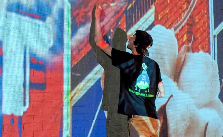 Only 28 years old, artist Malcom Byers commences his painting project at 915 West Ave. on Tuesday, June 10. The process involves using a projector at nighttime to create an outline for the expansive mural assignment. Orian Sain