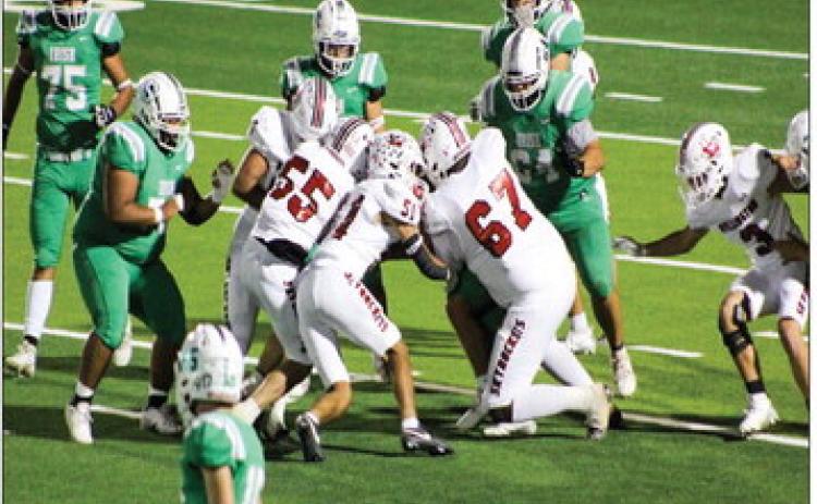 Wellington’s Jackson Jones (55), Kingston Molina (51), Jovani Munn (67), Yobani Moreno (65), Caleb Strickland (8) and Gunner Guy (3) cloud the Shamrock Irish offense during the Skyrockets’ 56-14 sweep Friday, Oct. 25 at El Paso Field in Shamrock. The Red River Sun/Shauna Salinas