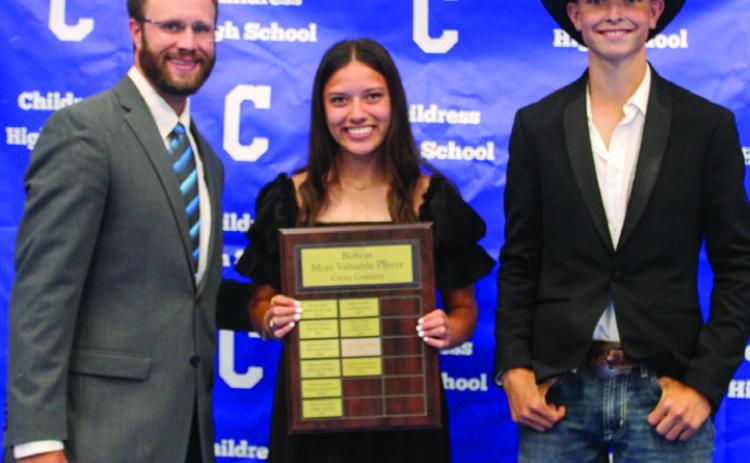 Athletic Director Bo Helm, left, awards Lady Cat Cross County Most Valuable Player (MVP) Clarissa Gamboa, center, and Bobcat Cross Country MVP Austin Bradley, right.