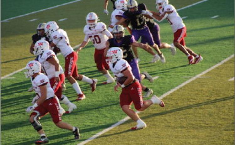 Skyrocket Gatlin Guy (3) merely escapes a Panhandle Panther while gaining yardage with blocking by Dakota Marshall (6), Ramon Rodriguez (51), RJ Granadoz (60), Caleb Strickland (50), Ethan Nevarez (44) and Bryant Tarver (11). Tied at the final buzzer, Panhandle took the 38-32 win in overtime. The Red River Sun/Shauna Salinas