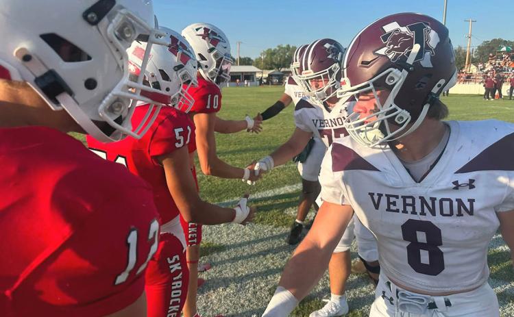 Wellington team captains for the week, Callen Kane (12), King Molina (51), Jake Chandler (10) and Hunter Hedrick (52), not pictured, meet up with the Vernon Lions team captains before the game last Friday, Sept. 4 on Powell Field. PHOTO BY RUBEN ON THE ROAD
