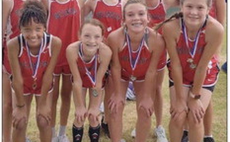 The Wellington Lady Firecrackers captured the cross country championship title at the Wheeler Invitational Saturday, Sept. 24. Four medaled, including Taytum Kane, who placed second, Aizlyn Menefield, who placed fifth, Ellie Thomas, who placed eighth, and Ceighley Killian, who placed ninth. Front row, from left: Menefield, Kane, Killian, Thomas. Back, from left: Addi English, Ingrid Granadoz, Anna Henard, Elli Ouellette, Maci Brewer. Courtesy Photo
