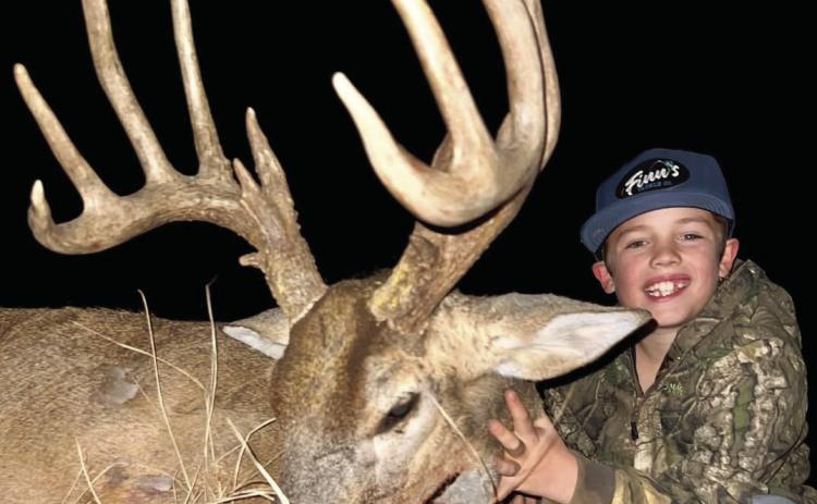Hunting with his grandad, Plaska Lodge owner Oren Don Molloy, and his dad, Colt Molloy, eight-year-old Finn harvested his first buck on Tuesday, Dec. 31. Photo Courtesy of Plaska Lodge