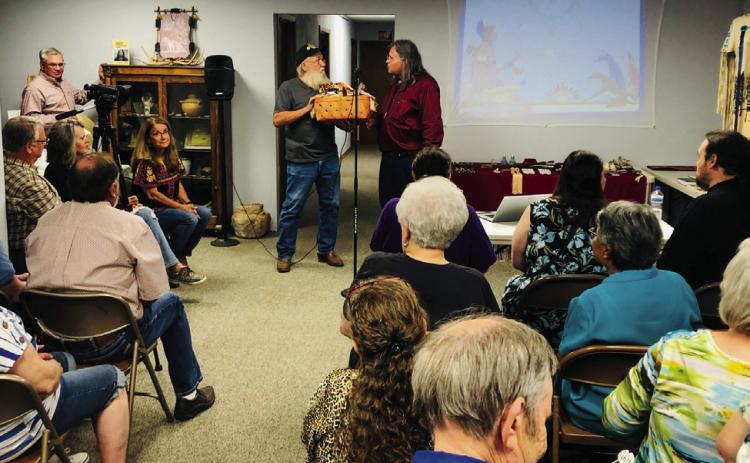 Darrell Colson, 1st Lt. Commander of the Sons of Confederate Veterans (SCV), Charles Goodnight Frontier Reg. Camp 2280, presents Lance Tahmahkera, great-great-grandson of Quanah Parker, with a “local” basket of appreciation for his visit to Wellington following his 6 p.m. Friday, Oct. 4 Comanche story time at Collingsworth County Museum. The Red River Sun/Bev Odom