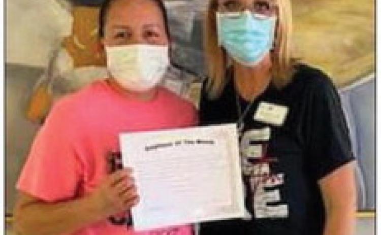 Wellington Care Center Administrator Nikki Hathaway, right, recognizes Virginia Granadoz as Certified Nurse Aid of the Month. She received a certificate and Walmart gift card. “Thank you for being someone we can always count on,” Hathaway said. Courtesy Photos