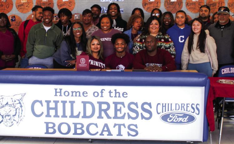 Lamont Nickleberry, surrounded by family, friends, teammates and coaches, signs his National Letter of Intent to play football for Trinity University on Thursday, Feb. 2 at Childress High School. The Red River Sun/Elizabeth Tanner