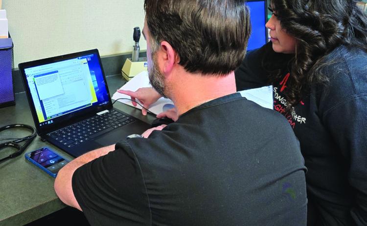 Ryan Roberson, APRN, FNP-C, and April Stephens, LVN, train intently on the new Electronic Medical Record (EMR) system last week. Photo Courtesy of Collingsworth General Hospital