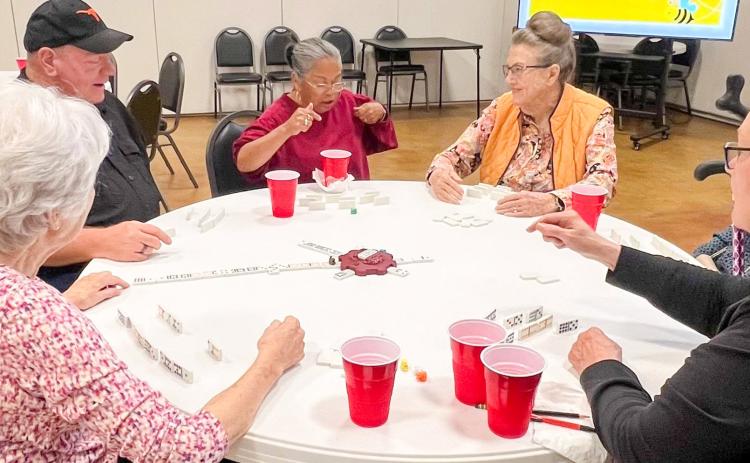 An intense game of Mexican Train Dominoes ensues during the May Wellington Senior Citizens Center Domino and Game Night social. Members enjoyed the hotdog meal, drink and dessert, along with the crazy competition and fun fellowship. From left: Linda Powell, Dave Hall, Eva Hamby, Sharon Starkey, Vada Wood, Marie White. WELLINGTON SENIOR CITIZENS CENTER