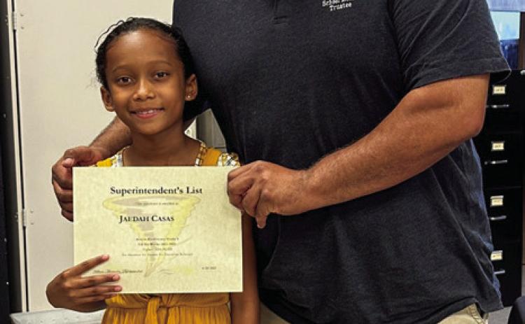 Third-grader Jaedah Casas is awarded by board members Joey Salinas.
