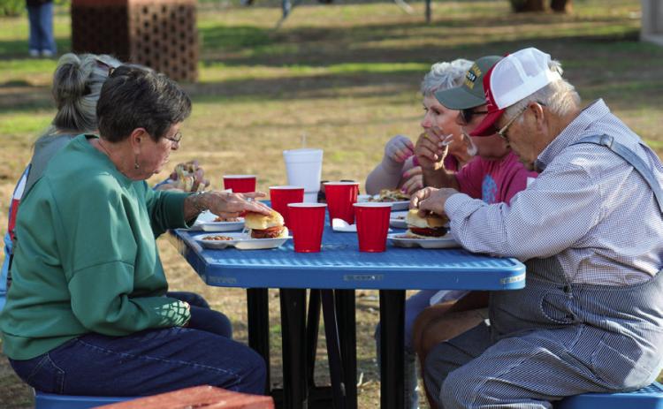 Attendees gather for barbecue hamburgers, including baked beans and iced tea, at the 69th Annual Memphis Lions Club Park Opener Friday, May 9 at Memphis City Park. The Red River Sun/Elizabeth Tanner