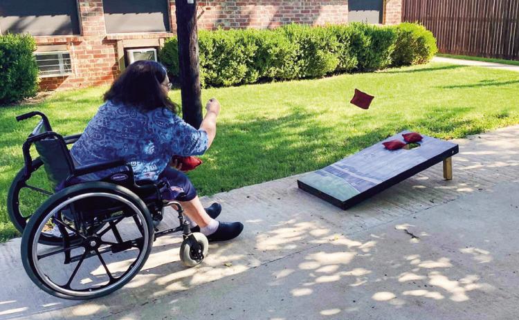 Care center creates corn hole competition