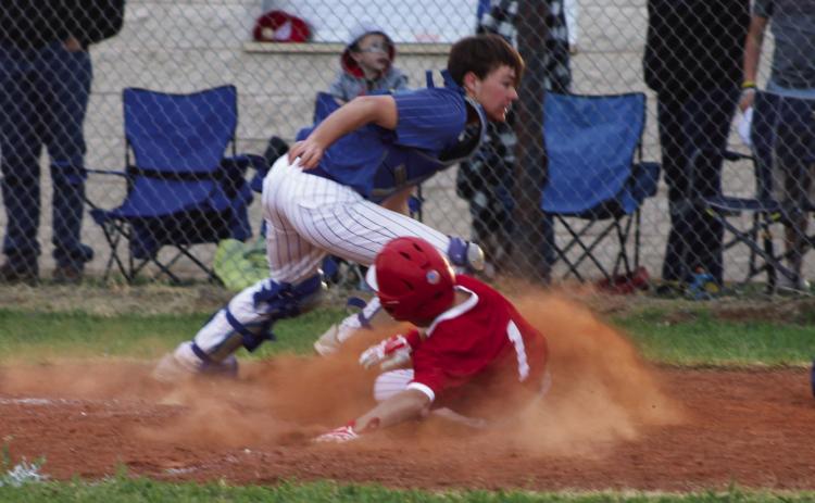 Wellington’s Major Brown (1) slides into home plate last Friday, March 24, scoring the game-winning run against the Nazareth Swifts in a 21-20 final. The Red River Sun/Shauna Salinas