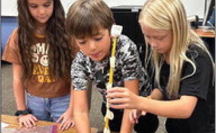 Second-graders Alora Cantu, left, Easton Ryan, Cora Henard.