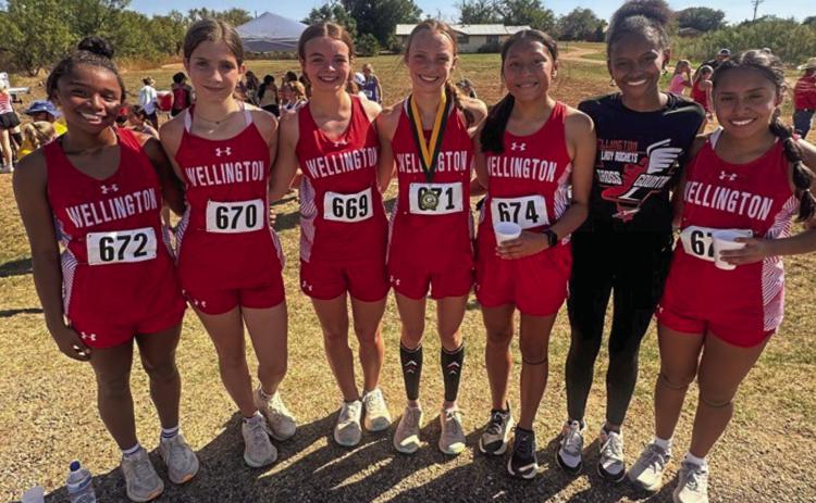 The Wellington Lady Rocket cross country team, including, from left, Aleah Lewis, Anna Henard, Addalyn English, Taytum Kane, Leslie Orozco, Angela Lewis and Sabrina Segovia, take their first team championship of the season at the Guthrie Rattlesnake Run Wednesday, Sept. 11. Courtesy Photo