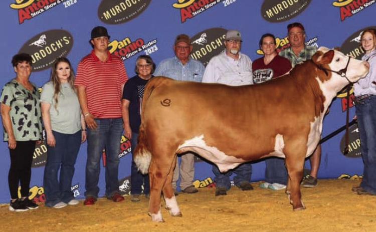 Bailey Page, an eighth grader at Wellington Junior High School, earns fifth place with her heavy weight Hereford “Astro” at the San Antonio Stock Show and Rodeo. From left: Trevor Rosso, Manda Gaskins, Hannah Worlein, Connor Cross, Teresa Gaskins, Kelly Gaskins, Jeremy Page, Katie Page, Van Gaskins, Bailey Page, Jacob Page. Courtesy Photo