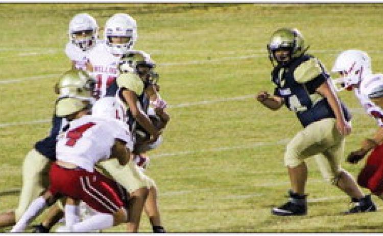 Junior varsity Skyrocket Noah Cantu (4) tackles a Memphis Cyclone with Anthony Ortiz (15), TJ Salinas (11) and Joey Orozco (33) rushing in to assist. The Rockets remain undefeated on the season, winning by a final score of 50-6. The Red River Sun/Shauna Salinas