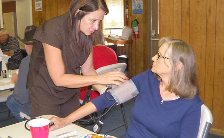 Visiting nurse gives blood pressure checks