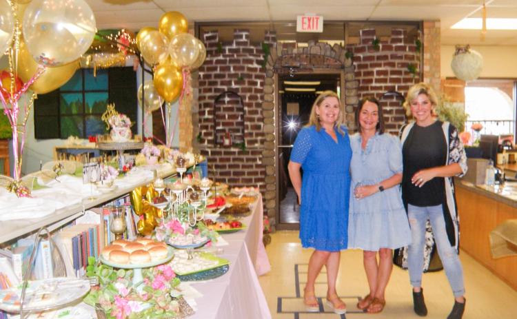 Childress Public Library hosts an Open House, celebrating 50 years at the library’s current location, 117 Ave. B NE, Monday, June 2. Ready to greet guests are, from right, Childress Public Library Librarian Summer Tropser, Angie Husband and Sarah Burton. Grace Holman